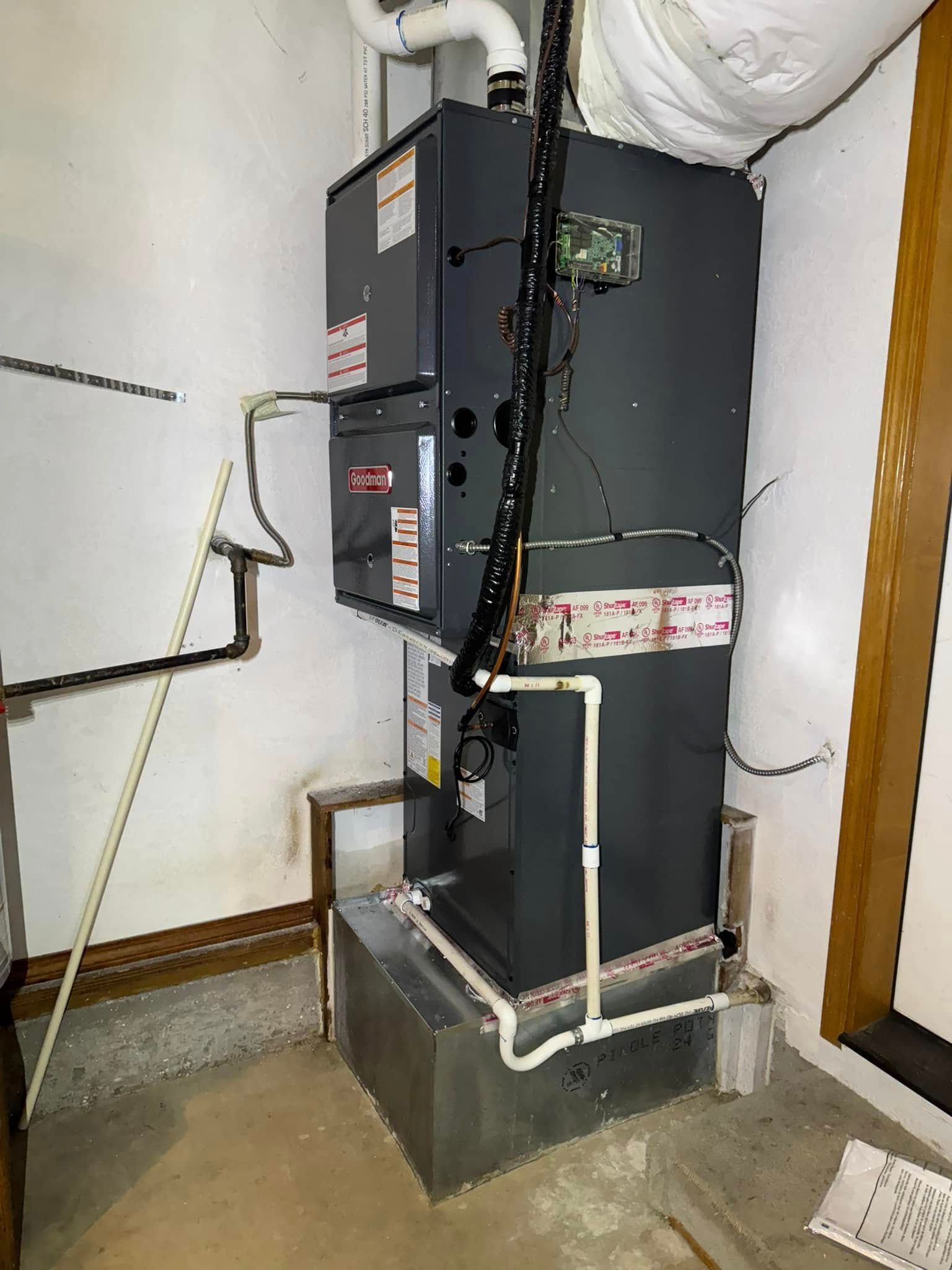 A large heater is sitting in a room next to a window.