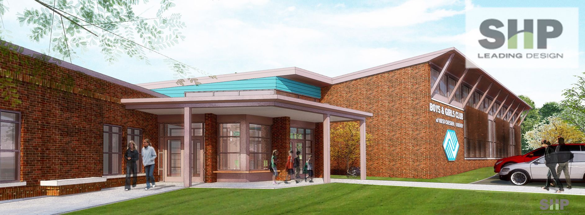 Building exterior with brick facade, porch, and a lawn. People and a car are present.