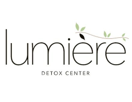 Logo for Lumiere Detox Center: black sans-serif text with a curved sprig of leaves.