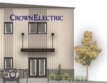 Crown Electric building with signage, windows, doors, a vehicle, and a tree.