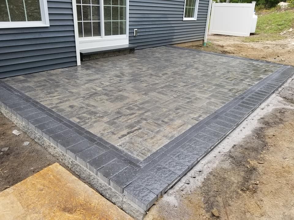 a patio is being built in front of a house