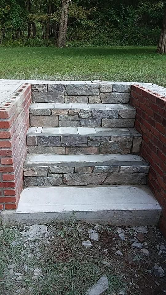 a set of stone stairs built into a brick wall