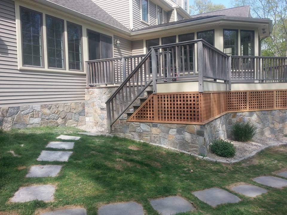 a house with a deck and stairs leading up to it