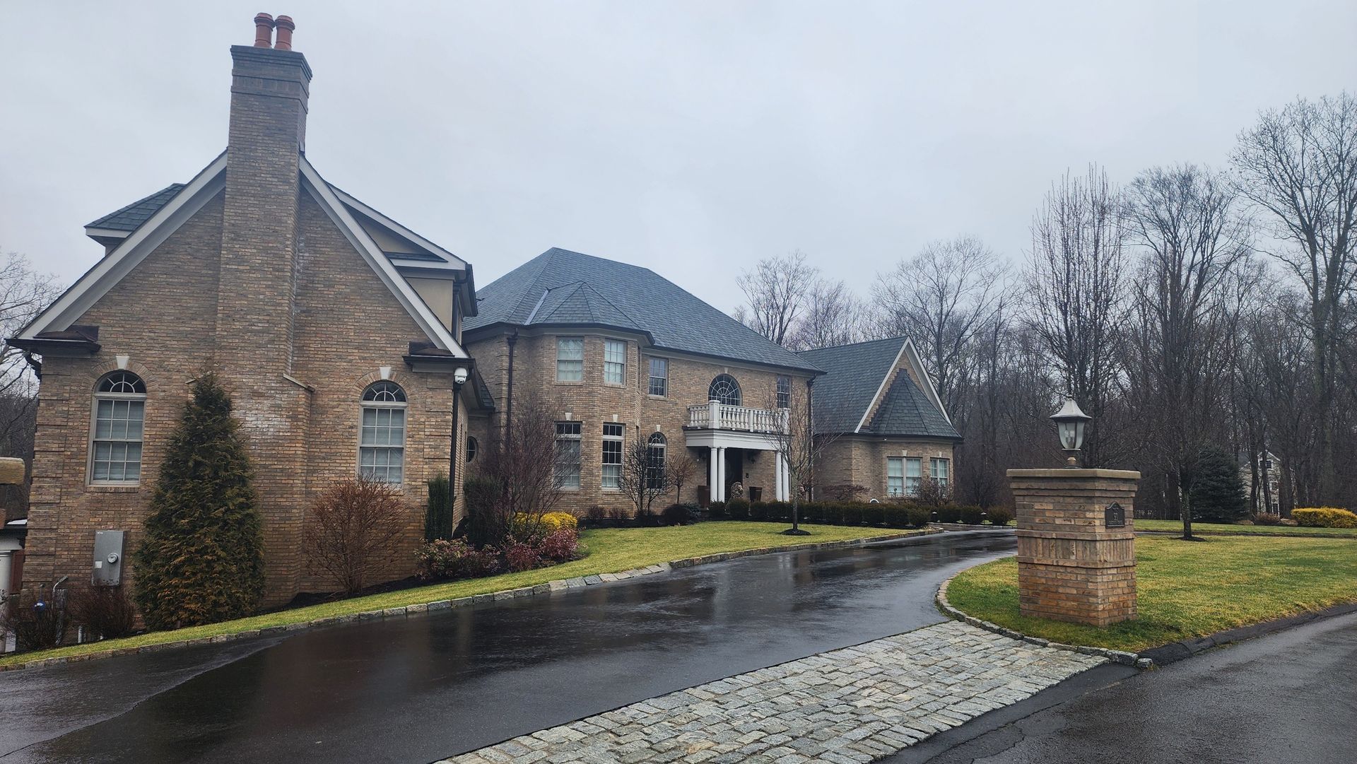a large brick house with a driveway in front of it