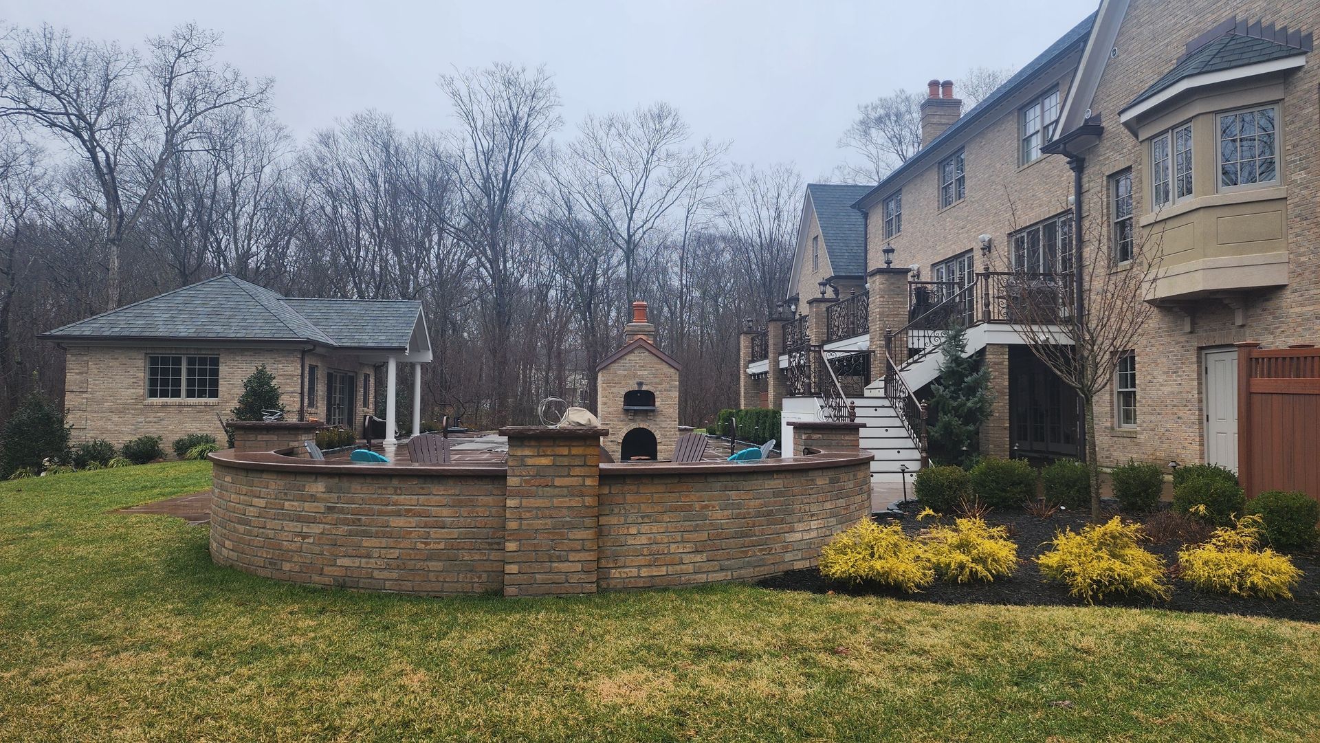 a large brick house with a large lawn in front of it