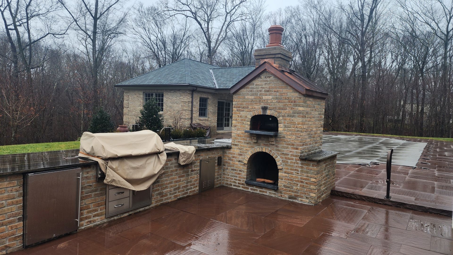 there is a large stone oven in the backyard of a house