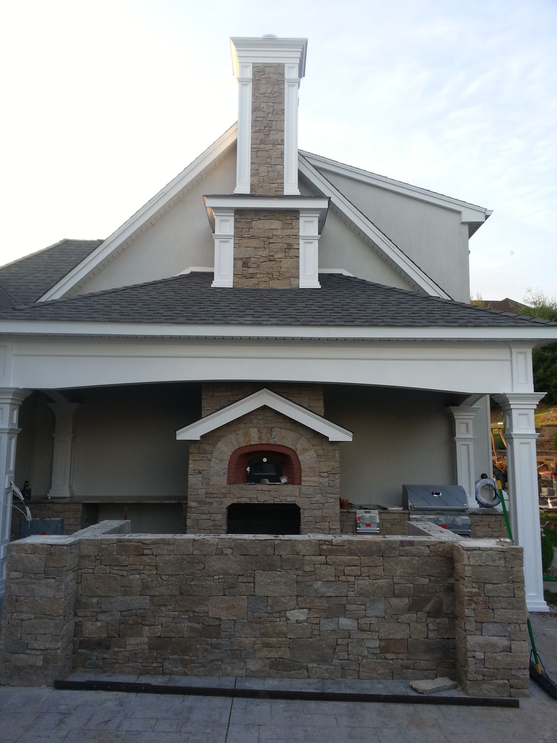 a house with a brick oven in front of it