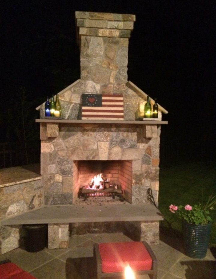 a fireplace with an American flag on top of it