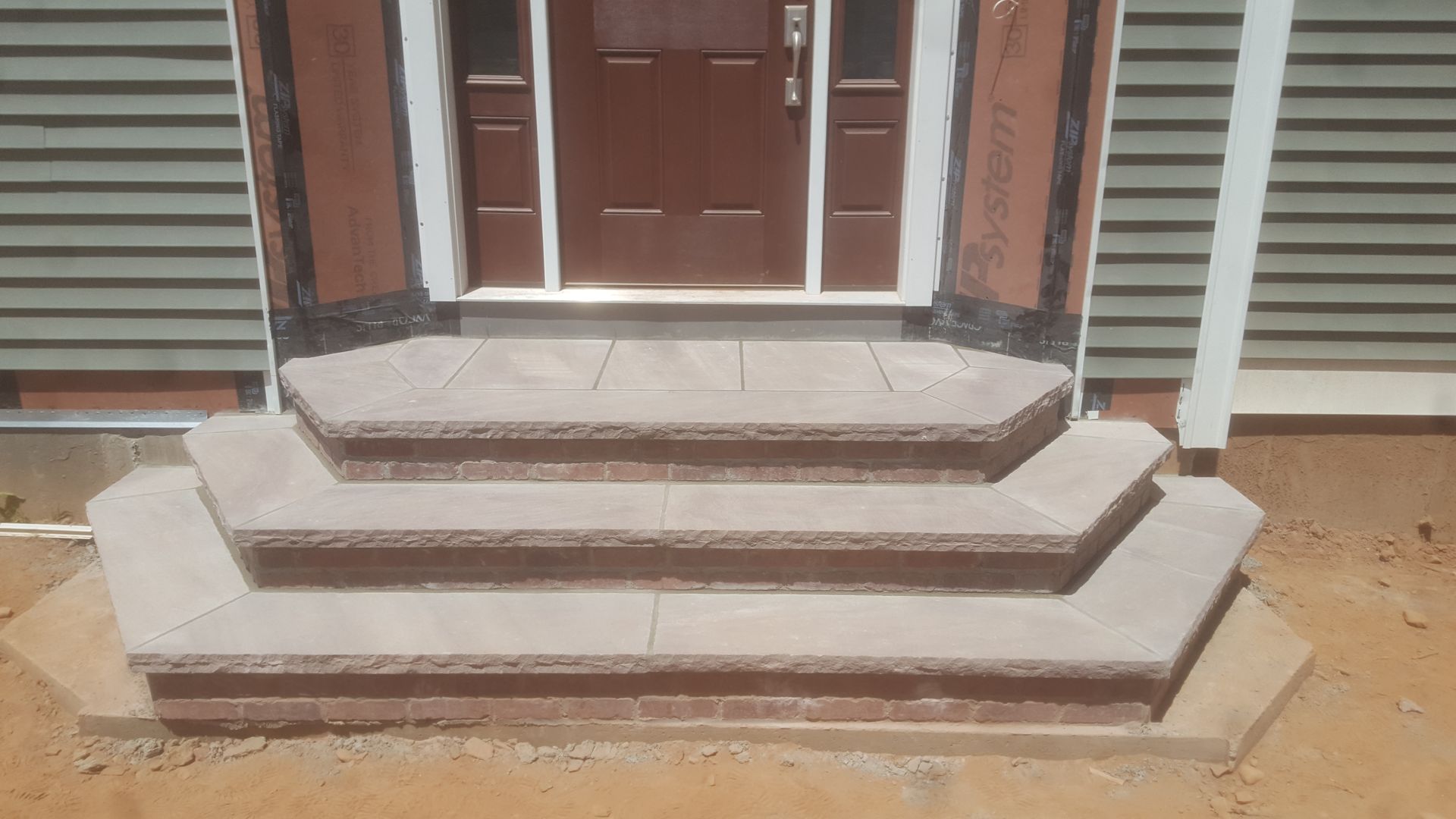 a set of stairs leading up to the front door of a house