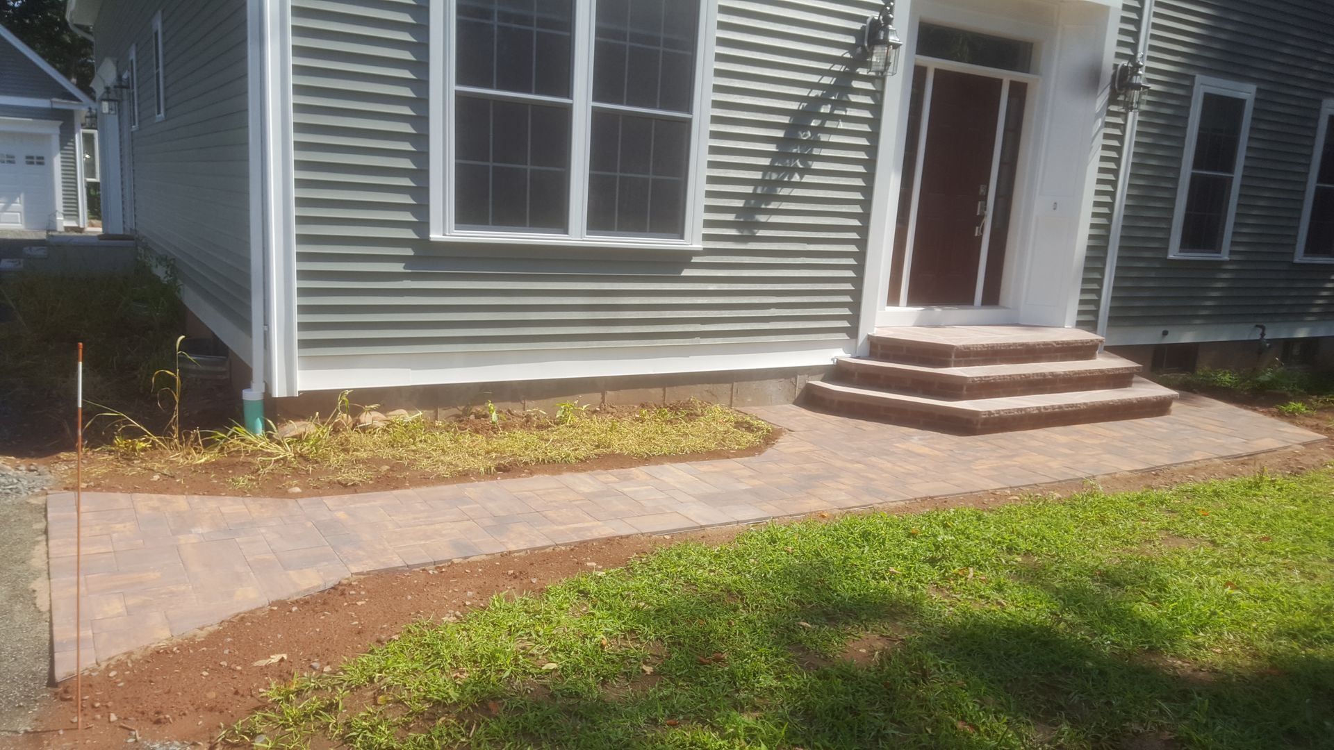 a house with a walkway leading to the front door and stairs