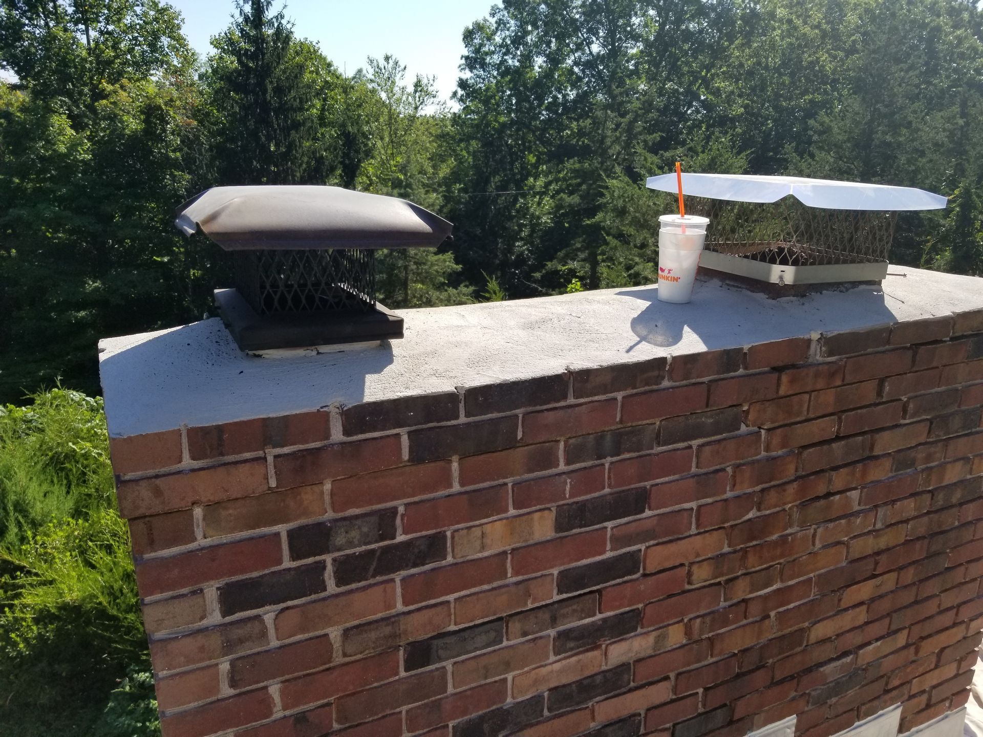 a brick chimney with a cup of coffee on top of it