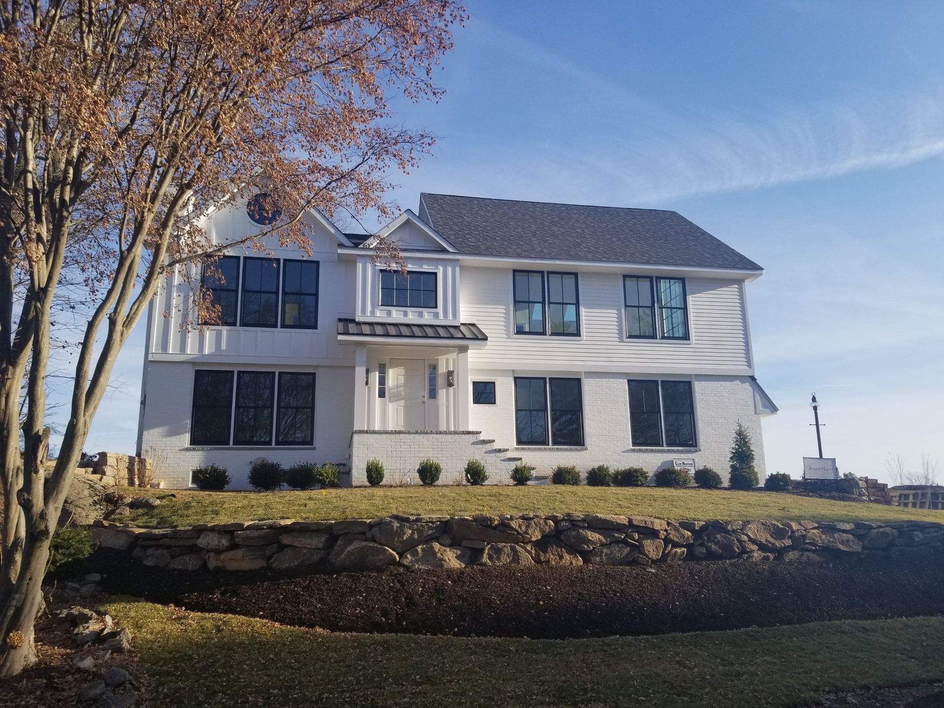a large white house with a tree in front of it