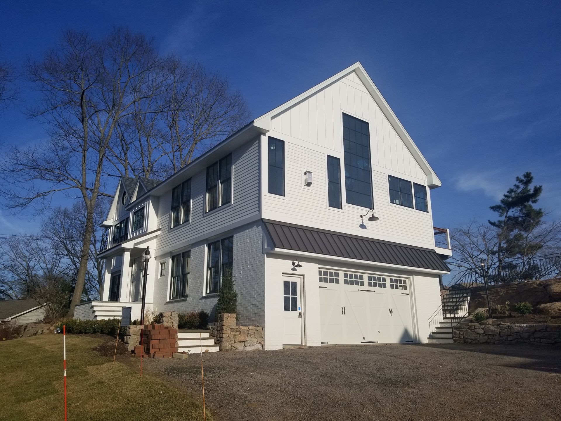a large white house with a black garage door