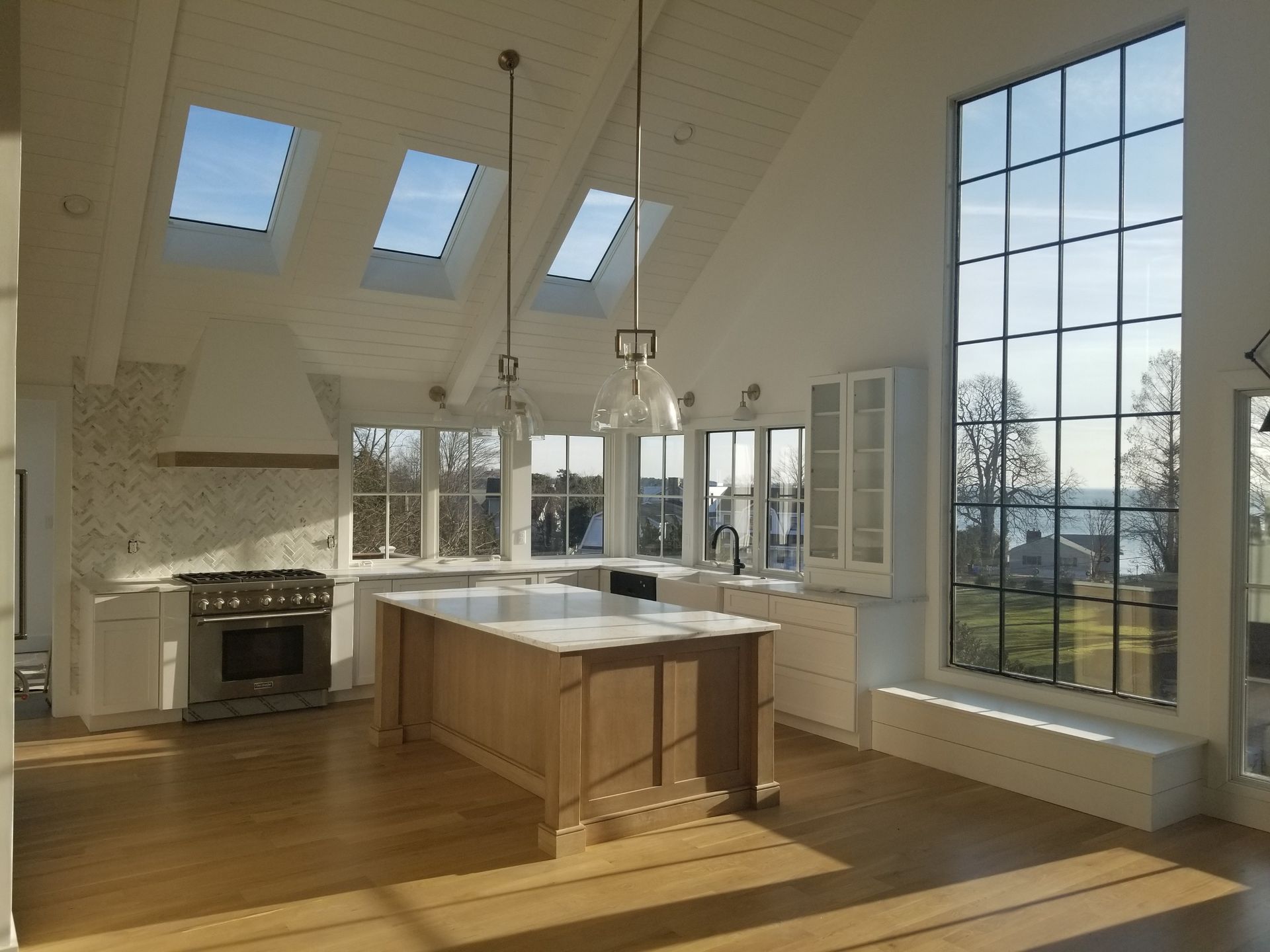 a kitchen with a large island and lots of windows