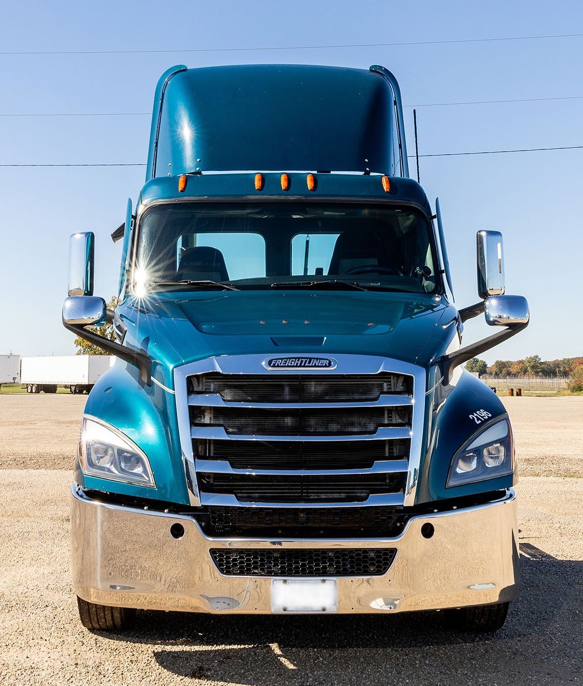 Blue Freightliner semi-truck parked outdoors