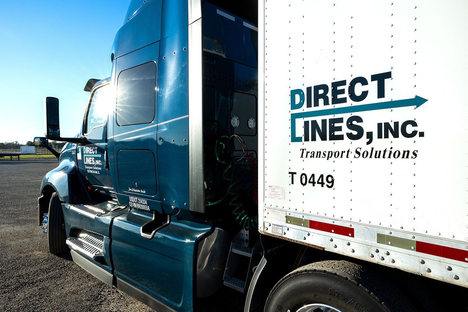 Blue semi-truck with a white trailer
