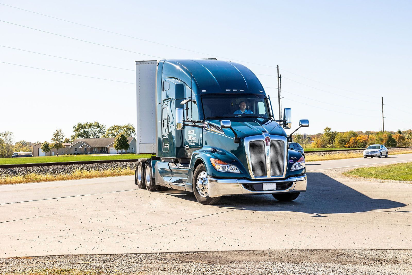 Blue semi-truck driving on a road