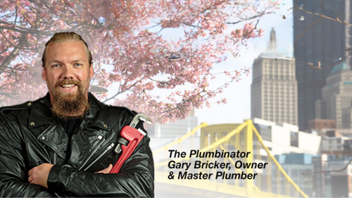 Man with beard in leather jacket holding a wrench, standing in front of city skyline with text 
