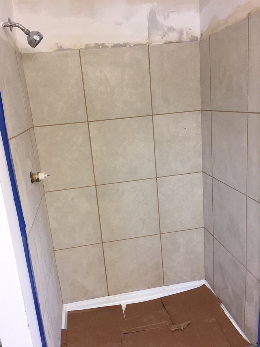 Newly installed show with ceramic tiled up wall