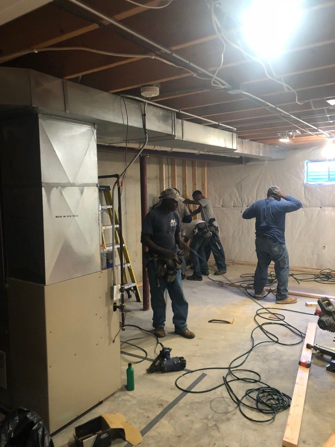 Men working in basement remodeling