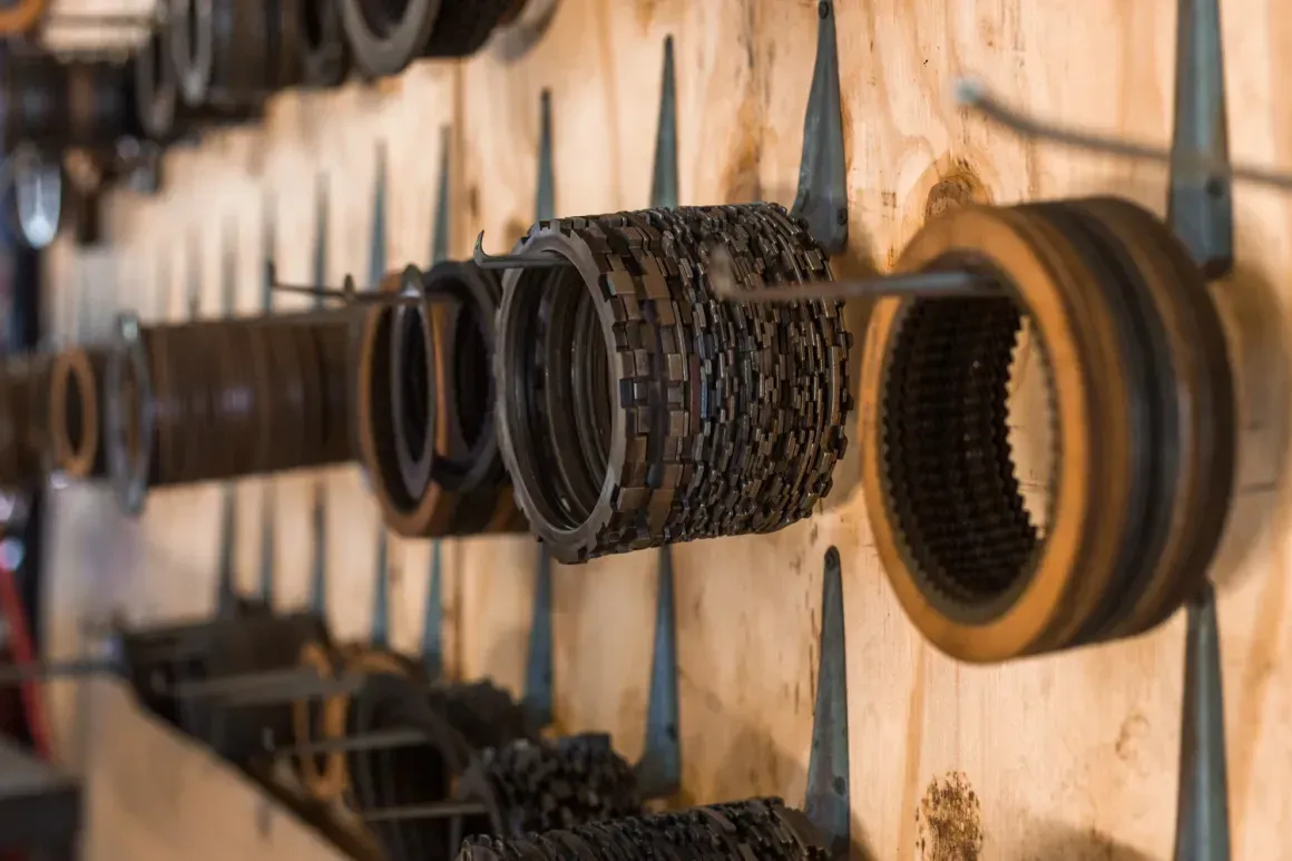 Assorted leather and woven belts hanging on pegs in a shop display