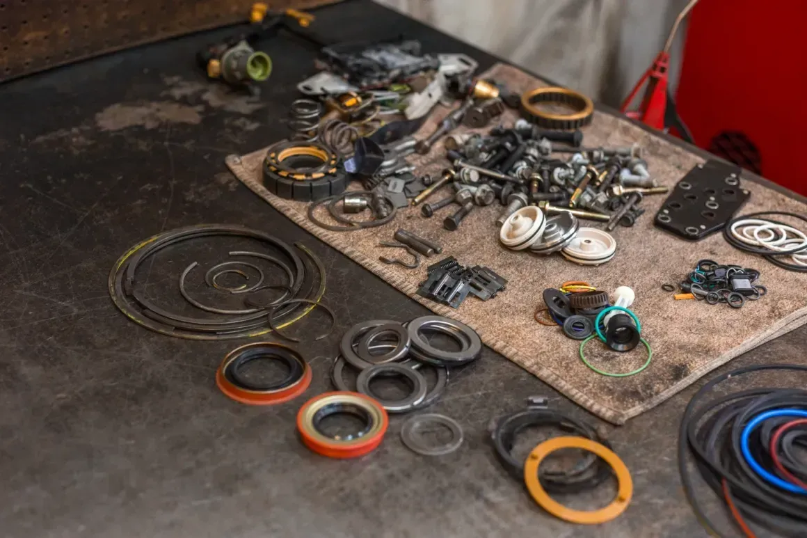 Scattered bicycle headset bearings and parts on a dark workbench with a cloth mat