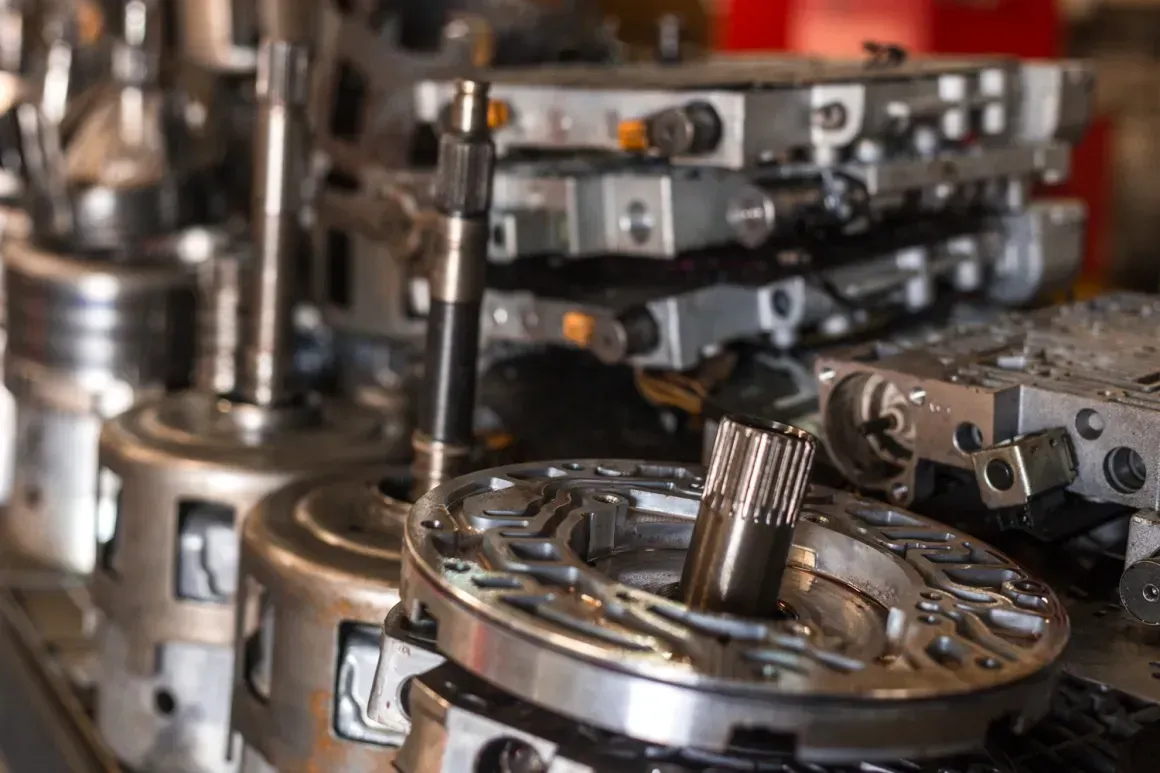 Close-up of shiny metal engine parts and gears in an industrial workshop