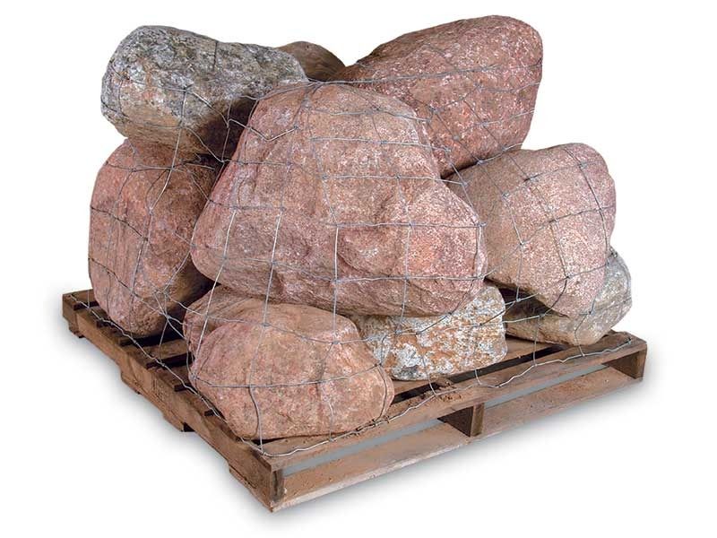 Stacked boulders wrapped in protective netting on a wooden pallet