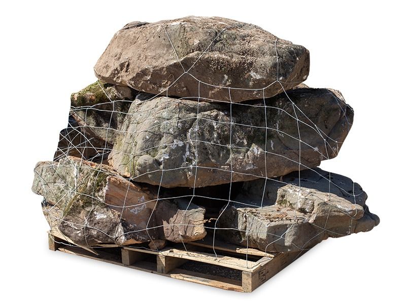 Stacked large rocks and boulders secured on a wooden pallet with netting