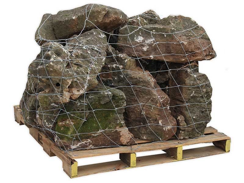 Wooden pallet stacked with large netted boulders or landscaping rocks