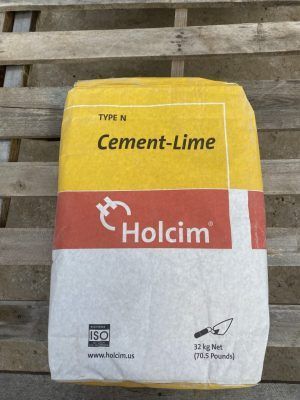 Holcim Cement-Lime bag with yellow, red, and white packaging on a wooden pallet
