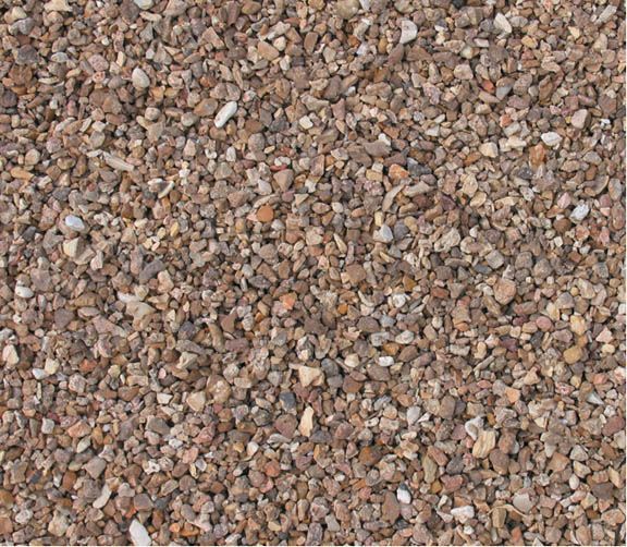 A close-up view of small, multi-colored gravel stones in shades of brown, gray, and beige.