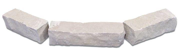 Three rectangular, rough-hewn light gray stone blocks arranged in a slight curve against a white background.