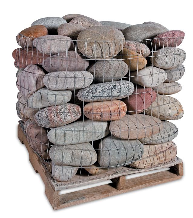 A pallet filled with assorted smooth, multi-colored river stones held in place by a wire mesh cage.