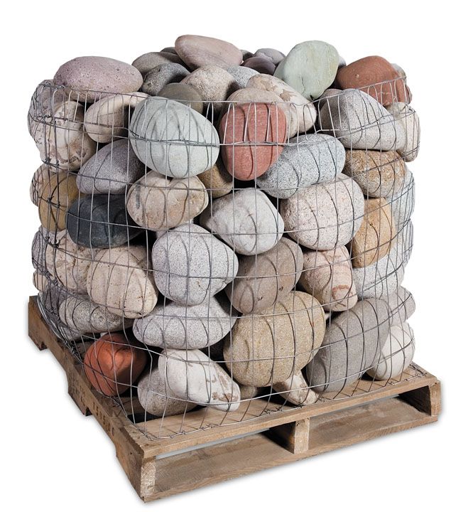 A pallet filled with large, multi-colored river stones held together by a wire mesh cage.