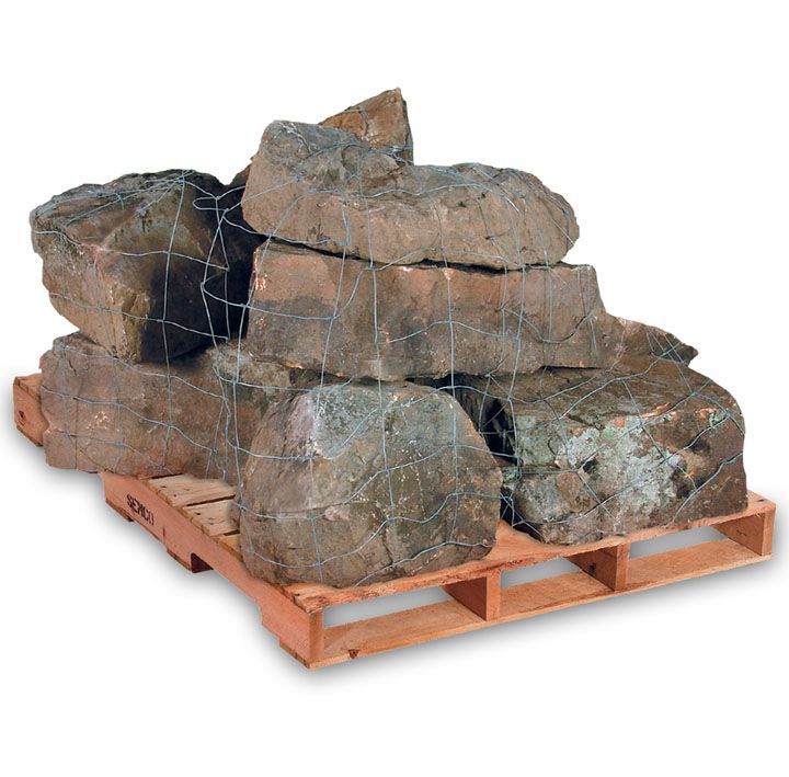 A pallet of large, irregularly shaped grey landscape boulders secured with wire netting.