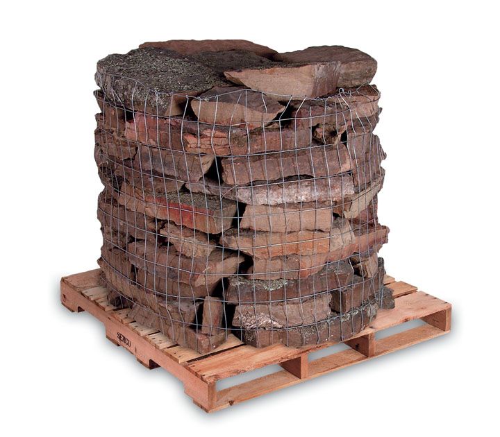 A stack of flat, brown, rustic natural stones secured in a wire crate on a wooden pallet.