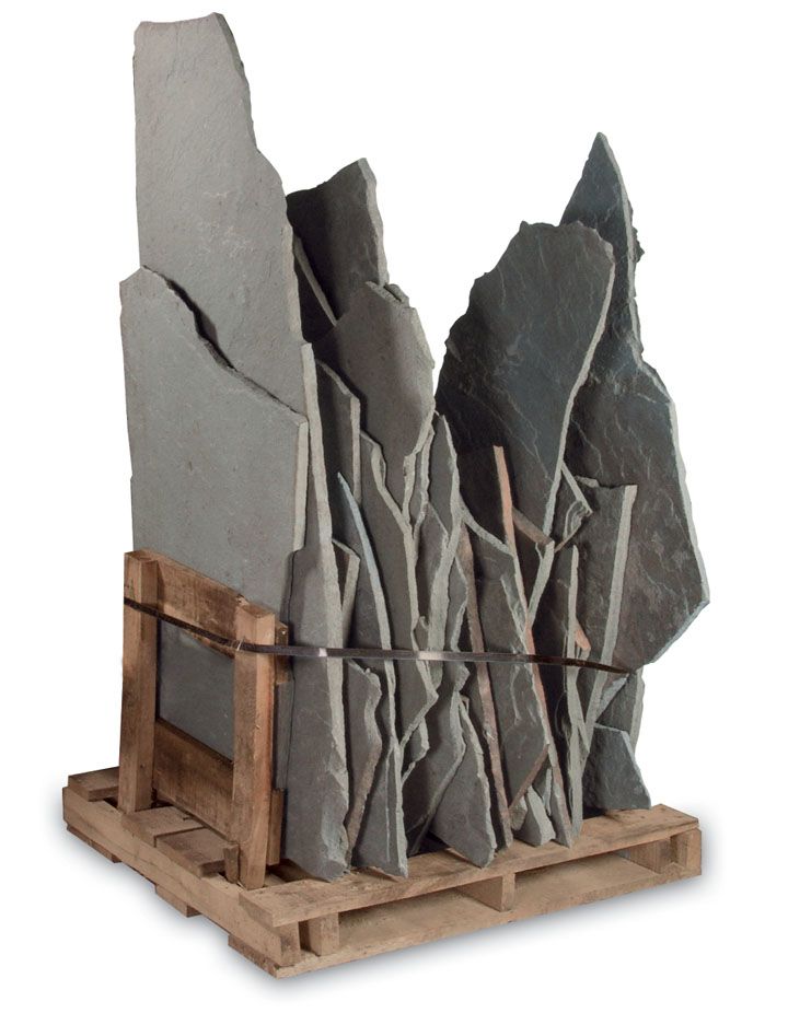 A wooden pallet holding a large stack of vertical grey slate slabs secured with a black banding strap.