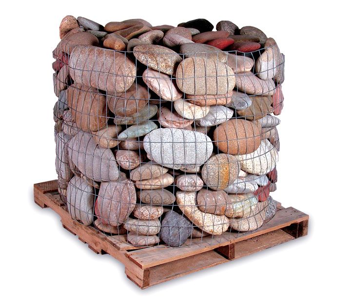 A pallet loaded with a wire cage filled with various smooth, multi-colored river stones.