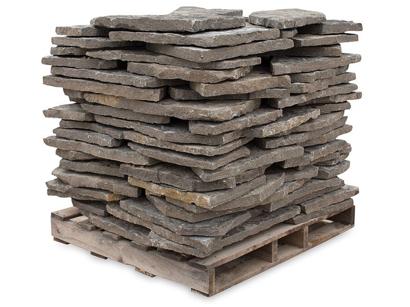 A pallet stacked with flat, grey-brown rectangular natural stone pavers against a plain white background.