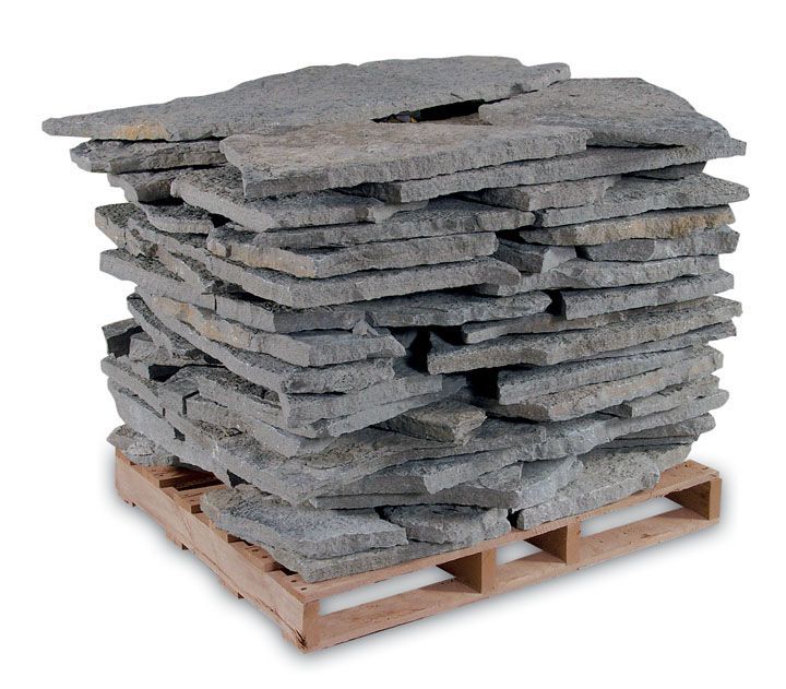 A wooden shipping pallet loaded with a tall, dense stack of flat, gray natural stone slabs.