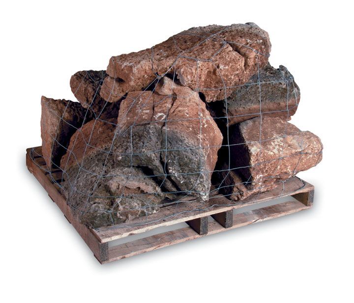 A wooden pallet stacked with large, rough, reddish-brown rocks, secured with wire mesh netting.