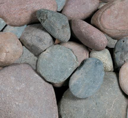 A close-up view of smooth, rounded river stones in shades of grey, tan, and reddish-brown.