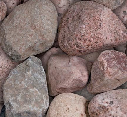A collection of smooth, multi-colored river stones in shades of pink, tan, and grey.