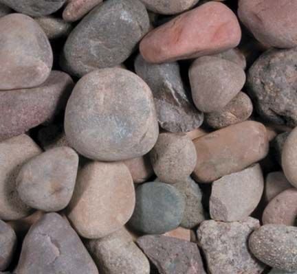 A close-up view of smooth, rounded river stones in various shades of gray, brown, and tan.