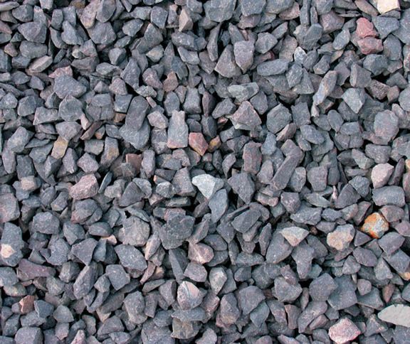 Close-up of gray and black gravel stones with a few white and orange pieces
