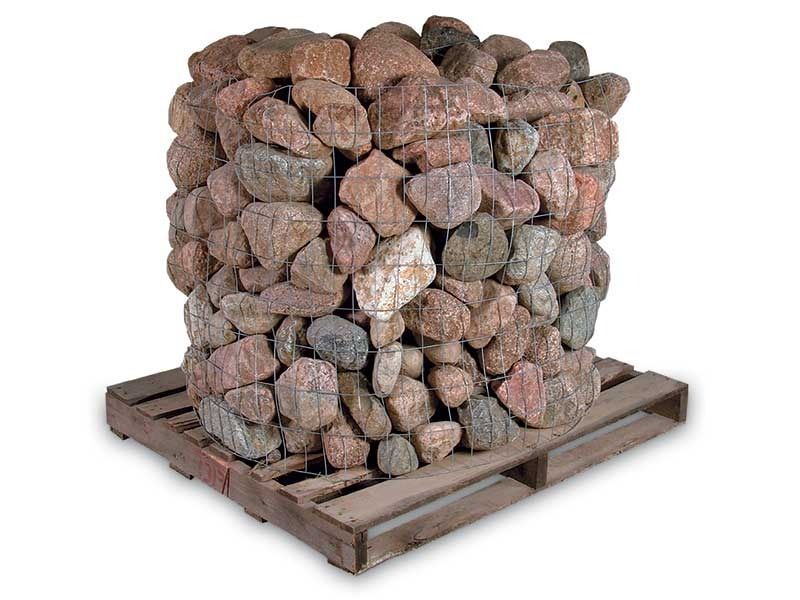 Stacked firewood logs on a wooden pallet, bundled and wrapped in netting