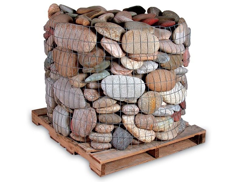 Stacked wire mesh baskets filled with assorted rocks on a wooden pallet