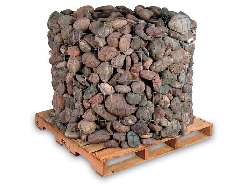 Pallet stacked with large net bags of mixed brown and gray rocks