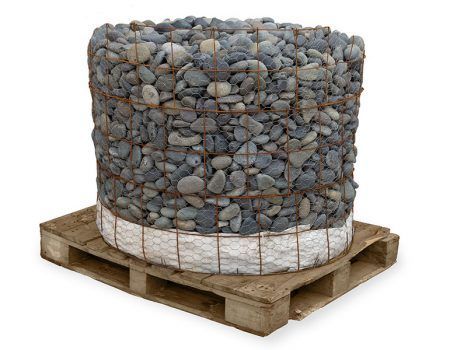 Large wire basket filled with gray stones sitting on a wooden pallet